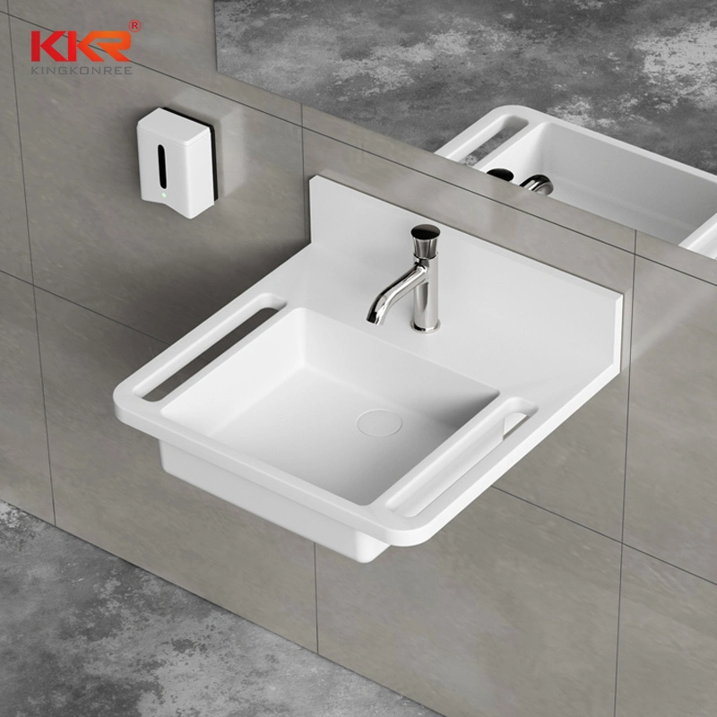 Wandgemonteerde wastafel van massief composietmateriaal van ziekenhuiskwaliteit met geïntegreerde handgrepen, voldoet aan de ADA-richtlijnen voor medische en gezondheidszorgtoepassingen. 1